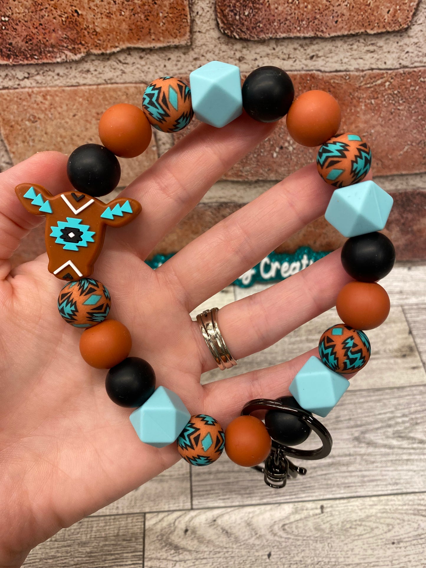 Rust Aztec Cow silicone wristlet keychain