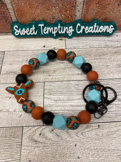 Rust Aztec Cow silicone wristlet keychain